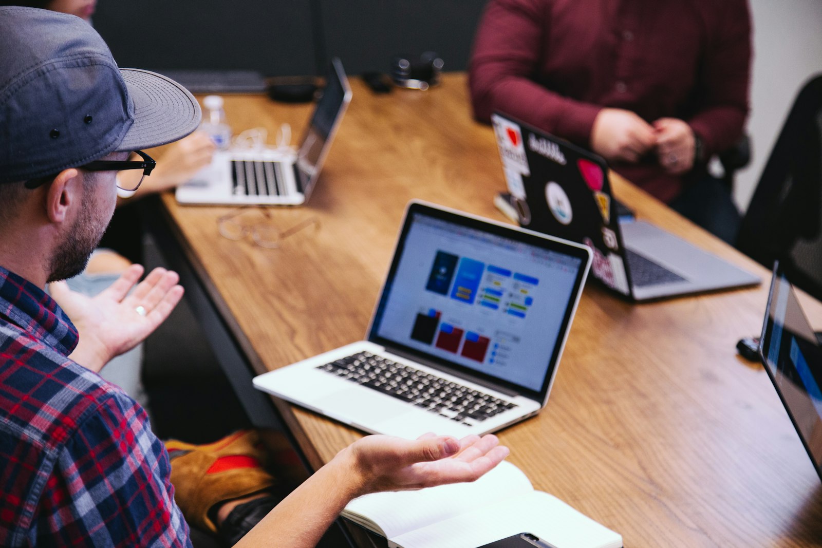 Colleagues in a candid and focused discussion around a worktable